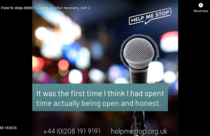 A microphone on a stand with bright lights at night in the background