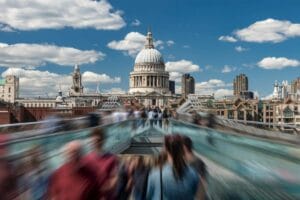Busy commuters rushing to work, crossing the River Thames to St Paul's Cathedral, London